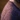 Close-up of a person wearing a knitted garment with a patterned shoulder.