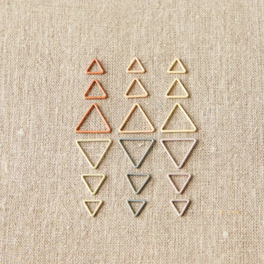 Triangle Stitch Markers from Cocoknits in earth tone colors on fabric
