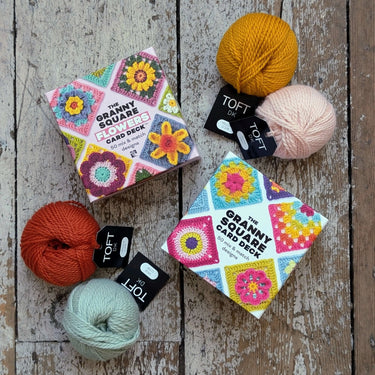 Granny Square and Flower Card Decks with colorful yarn balls for crochet projects