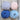 Four balls of yarn in pale pink, lavender, deep blue, and light blue on a rustic wooden surface.