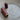 Wooden darning needle case with 3 metal darning needles on table.