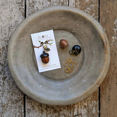 Acorn Stitch Marker Case with 10 Ring Stitch Markers displayed on rustic wooden surface.