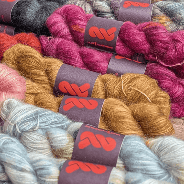 A&P Lace Silk Mohair yarn in vibrant hand-dyed colors, showcasing luxurious fluffy texture and unique skeins.