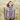 Woman wearing Aran by Marie Wallin designed Fairisle cardigan in field.