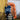 Woman in blue striped sweater for Archipelago Knitting pre-order, holding rope by orange buoy.