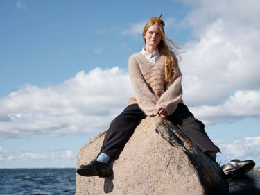 Art of the Sea knitwear design inspired by the Moomins, featuring serene seaside fashion. Pre-order now from Laine.