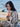 Woman wearing knitwear inspired by The Art of the Sea, sitting by the ocean.