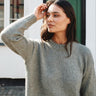 Astrid Sweater Kit knitted in green KFO Merino and Soft Silk Mohair, worn with a hand in the hair, at Knit With Me yarn shop