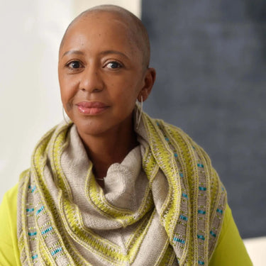 Woman wearing knitted scarf showcasing Beaded Colourwork style