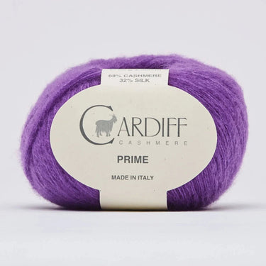 Purple yarn ball with a Cardiff Cashmere label on a light gray background