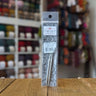ChiaoGoo Twist Lace Tips - Metal interchangeable knitting needles in packaging on wooden surface, colorful yarns in background.