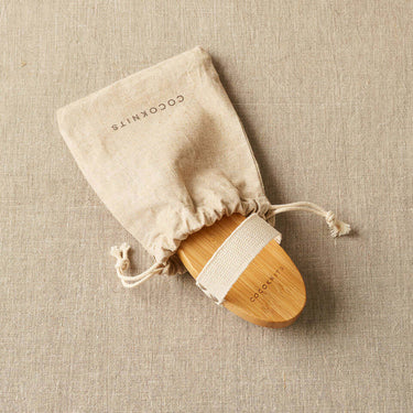 Cocoknits Sweater Care Brush with linen storage pouch for refreshing textiles, depilling clothes, and removing lint from fabrics.