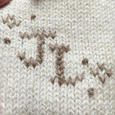 Close-up of Duplicate Stitch embroidery on knitted fabric, showcasing detailed craftsmanship for the embellishment workshop with Justine Lee.