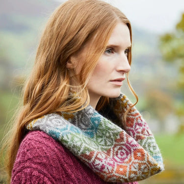 Woman wearing colorful Ennerdale Cowl Kit by Marie Wallin, showcasing intricate Fairisle knitting design from Westmorland collection