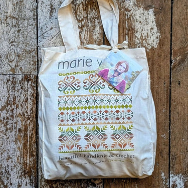 Ennerdale Cowl Kit by Marie Wallin tote bag on a wooden floor with colorful knitting pattern design.