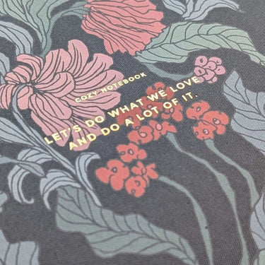 Flower Notebook with colorful floral design and inspiring quote on cover.