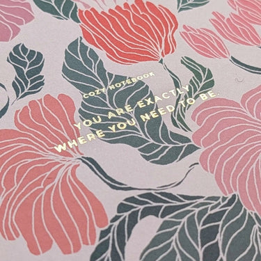 Flower Notebook with floral motif and motivational quote on the cover.