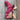 Ainsworth & Prin Flower Yarn Knitting Kits with pink skeins and silk ribbon on a wooden background.