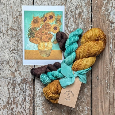 Ainsworth & Prin Flower Yarn Knitting Kits with Classic Sock base and hand-dyed silk ribbon on rustic wood background.
