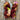 Two skeins of multicolored yarn on a wooden surface