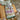 Marie Wallin's Winter Hot Water Bottle Cover with Fairisle design, crochet drawstring, and flower embellishments