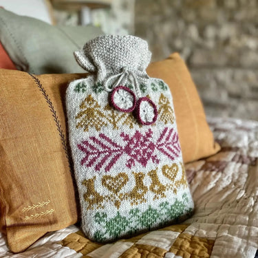 Marie Wallin's Winter Hot Water Bottle Cover with Fairisle design, crochet drawstring, and flower embellishments