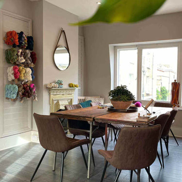 Cozy setting for Knit Clinic with yarn samples displayed in bright knitting workshop room.