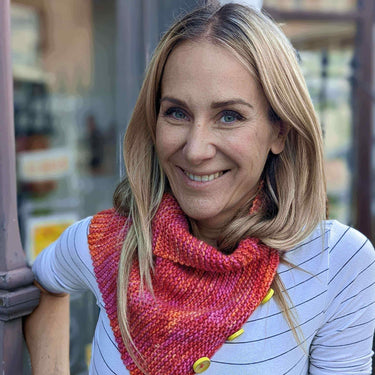 Woman wearing a hand-knitted scarf at Beginner Knitting Class