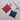 Two woven pouches, one red and one blue, on a light gray surface.