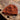 Brown knitted hat on a textured stone surface