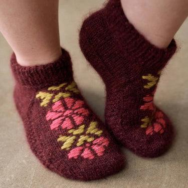 Knitted socks with floral pattern on a neutral background