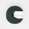 Knitting for Olive COTTON MERINO yarn ball in dark green, soft blend of cotton and Merino wool for versatile, year-round garments.