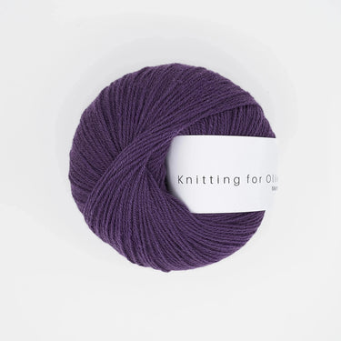 Knitting For Olive Merino yarn in deep purple, perfect for cozy knitting projects with natural fiber benefits.