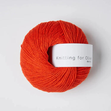 Knitting For Olive Merino yarn in vibrant orange color, ideal for cozy winter projects and outdoor adventures.