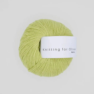 Knitting For Olive Merino yarn ball in light green color, ideal for cozy, breathable knit projects.