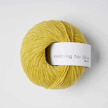 Knitting For Olive Merino yarn in yellow, fingering weight, ideal for knitting projects. Cozy and breathable wool skein.
