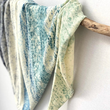 Textured yarn draped elegantly, part of the Kokon Blue Knit Me An Ocean Yarn Advent Calendar collection, focus on intricate fibers.