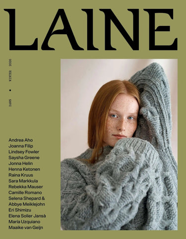 Cover of Laine Magazine Issue 27 - Winter featuring a model in a cozy cable knit, showcasing winter knitting designs.