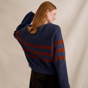 Model wearing knit sweater design from Laine Magazine Issue 27 - Winter, featuring bold stripes, available for pre-order.