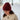 Woman wearing a handmade knitted red hat and cream sweater, inspired by Laine Magazine Issue 27 - Winter PRE-ORDER collection.