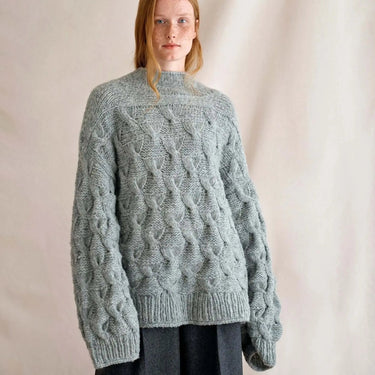 Laine Magazine Issue 27 winter knitting design featuring grey cable knit sweater.