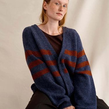 Model wearing knitted sweater from Laine Magazine Issue 27 - Winter PRE-ORDER, showcasing bold cables and colorwork.