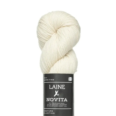 Ball of white yarn with Laine Novita label on a white background