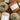 Skeins of Le Coton & Alpaca yarn in various colors on a wooden surface, ideal for spring and autumn knitting projects.