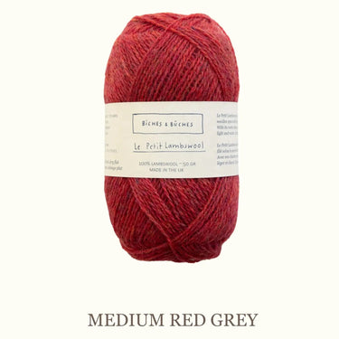 Red yarn ball with a label on a white background