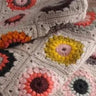 Colorful handmade granny square crochet blanket at Crochet a Granny Square Workshop.