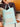 Hand holding a light blue crochet tote bag with a unique design, featured in Let's Crochet Issue 2 by Laine.