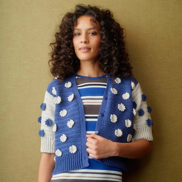 Woman wearing blue and white crochet cardigan featured in Let's Crochet Issue 2 by Laine