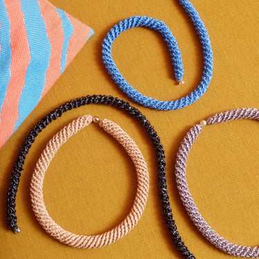 Colorful crochet necklaces on a yellow background, showcasing projects from Let's Crochet Issue 2 by Laine magazine.