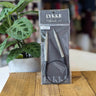 LYKKE brand knitting needles in packaging on a wooden table with a plant in the background at knit with me yarn shop